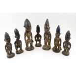 TRIBAL FIGURES, a convocation of seven male and female Yoruba people wooden figure carvings,