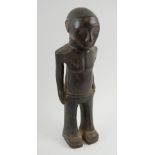 COLON FIGURE, circa 1970's, Bamana people, carved wood depicting a man in flared trousers, 47cm H.