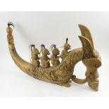 DRAGON CARVING, wooden, being ridden by five figures, 73cm L overall.