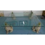 LOW TABLE, having a large square bevelled edge glass top raised on four Buddhistic lion supports,