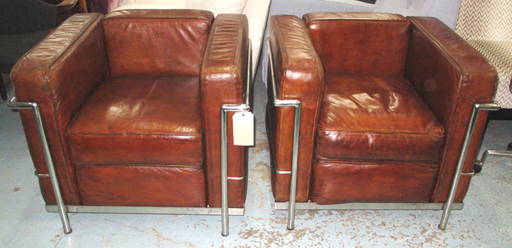 ARMCHAIRS, a pair, Le Corbusier design tubular chrome framed with tan leather cushions, 77cm W.