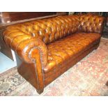 CHESTERFIELD SOFA, traditional faded tan leather with deep button curved back and arms.