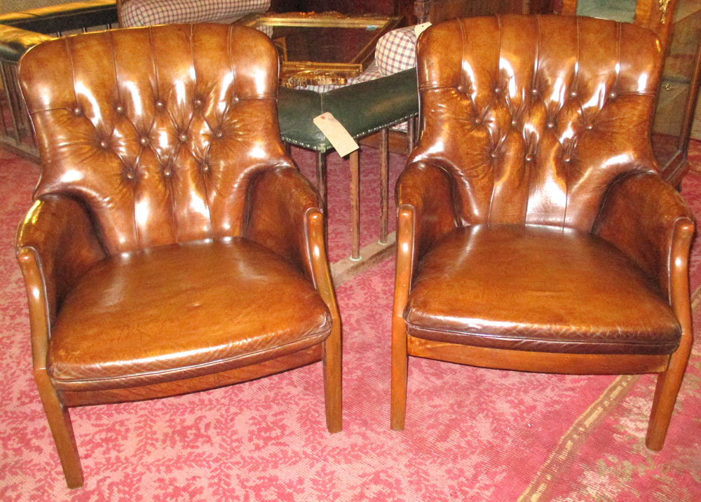 ARMCHAIRS, a pair, vintage faded tan brown buttoned leather each with cushion by Parker Knoll.