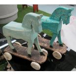 WOODEN TOY HORSES, a matched pair, on wheels, distressed painted finish, 1950's style,