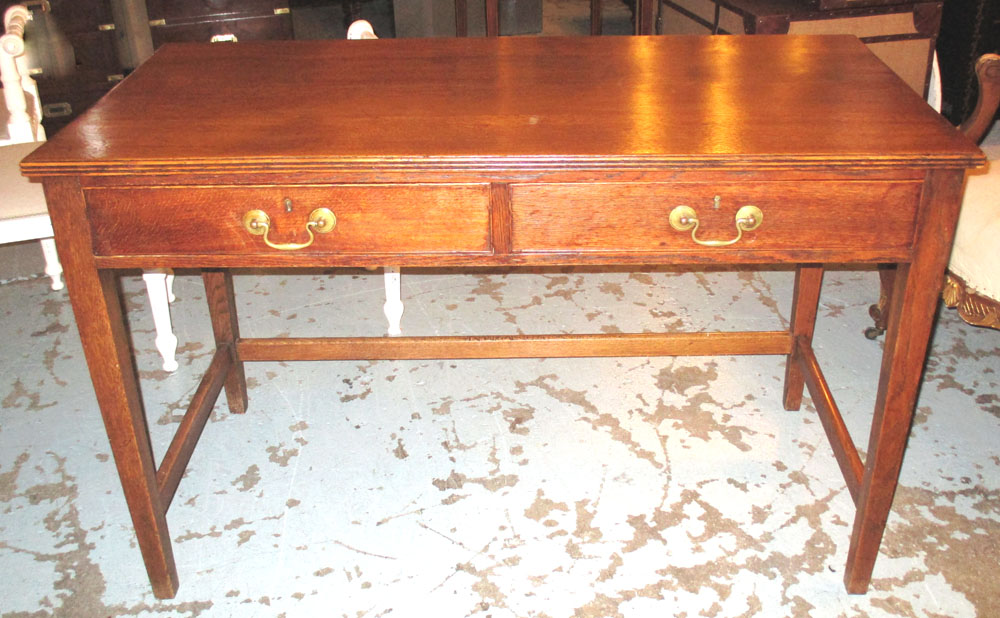 WRITING TABLE, Edwardian oak with two drawers (Provenance: Sothebys Olympia) 76cm H x 122cm x 60cm.
