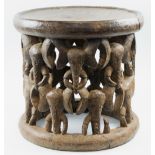 WEST AFRICAN KING'S STOOL, the supports carved multiple elephant heads, 50cm diam x 47cm H.
