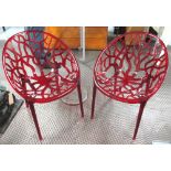 CHAIRS, a pair, contemporary in red intricate naturalistic cut out design, 60cm W.