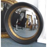 CONVEX BUTLERS MIRROR, circular in a black frame, 83cm diam.