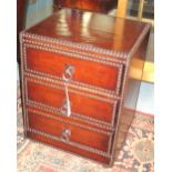 BEDSIDE CHESTS, a pair, faded tan brown leather and metal studded each with three drawers,