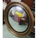 CONVEX MIRROR, Regency style giltwood with ebonised leaf decoration, 117cm diam.