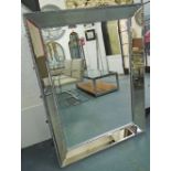 MIRROR, bevelled mirrored surround in a silver painted frame, 124cm x 93cm.