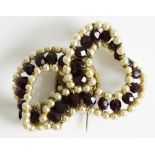 DEPOSE BOW BROOCH faux pearls set with garnet coloured faceted beads, signed Depose. W. 5.