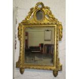 WALL MIRROR, Louis XVI giltwood with rectangular and oval plates under a tied ribbon crest,