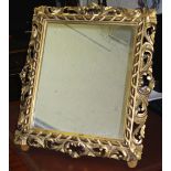 EASEL MIRROR, 19th century Florentine giltwood with rectangular pierced scrolling frame,