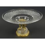 CUT GLASS TAZZA, 20th century the circular dish top supported by three gilt metal cherubs,