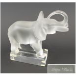 LALIQUE ELEPHANT PAPERWEIGHT, the plinth signed 'Lalique, France', 16cm L x 15.5cm H max.