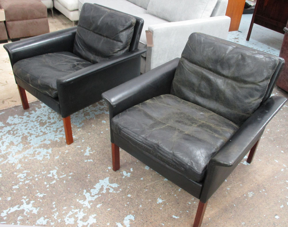 HANS OLSEN ARMCHAIRS, a pair, in black leather, with rosewood legs (with faults,