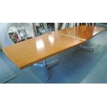 BOARDROOM TABLE, lozenge form, with wooden top, on a pair of support columns on triform base,