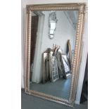 MIRROR, with bevelled plate, in an ornate silver painted frame, 187cm x 112cm.