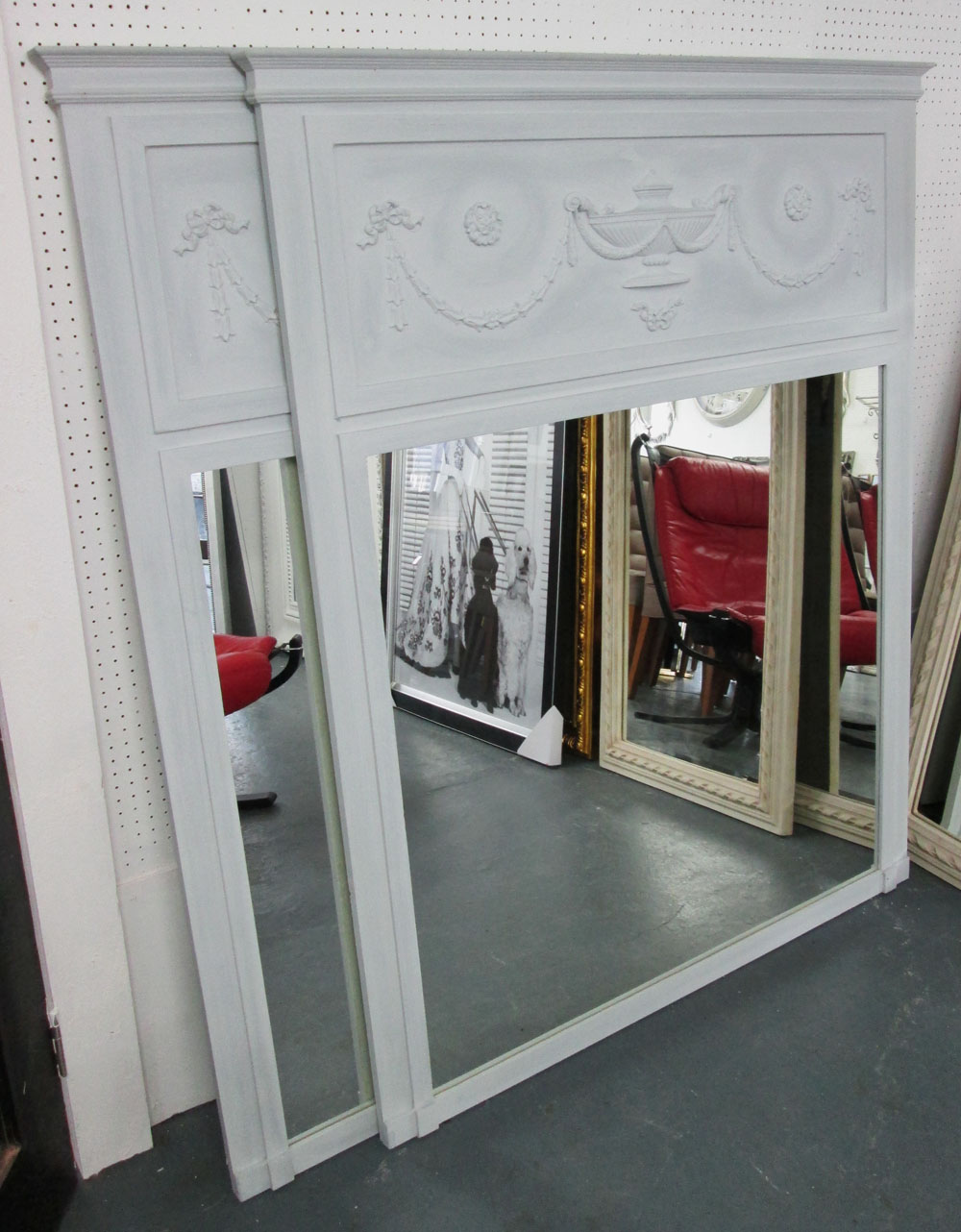 TRUMEAU MIRRORS, a pair, with classical motifs in a grey painted finish, 143cm x 114cm.