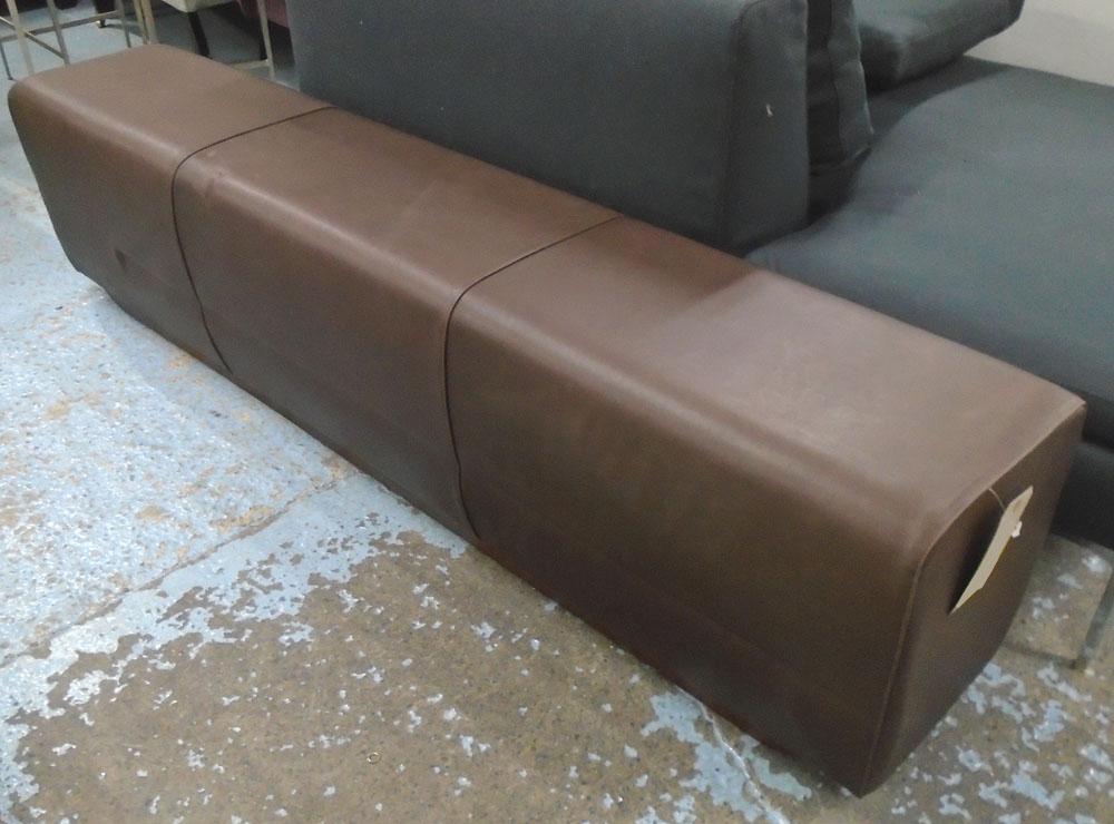 OTTOMAN, in burnt umber leather, on long wooden supports, 178cm L.