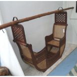 PALANQUIN, for two, carved teak with caned seats and bamboo carrying pole,