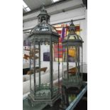 STORM LANTERNS, a large pair, 19th century style, glass lined metal frames, 101cm H x 29cm W.