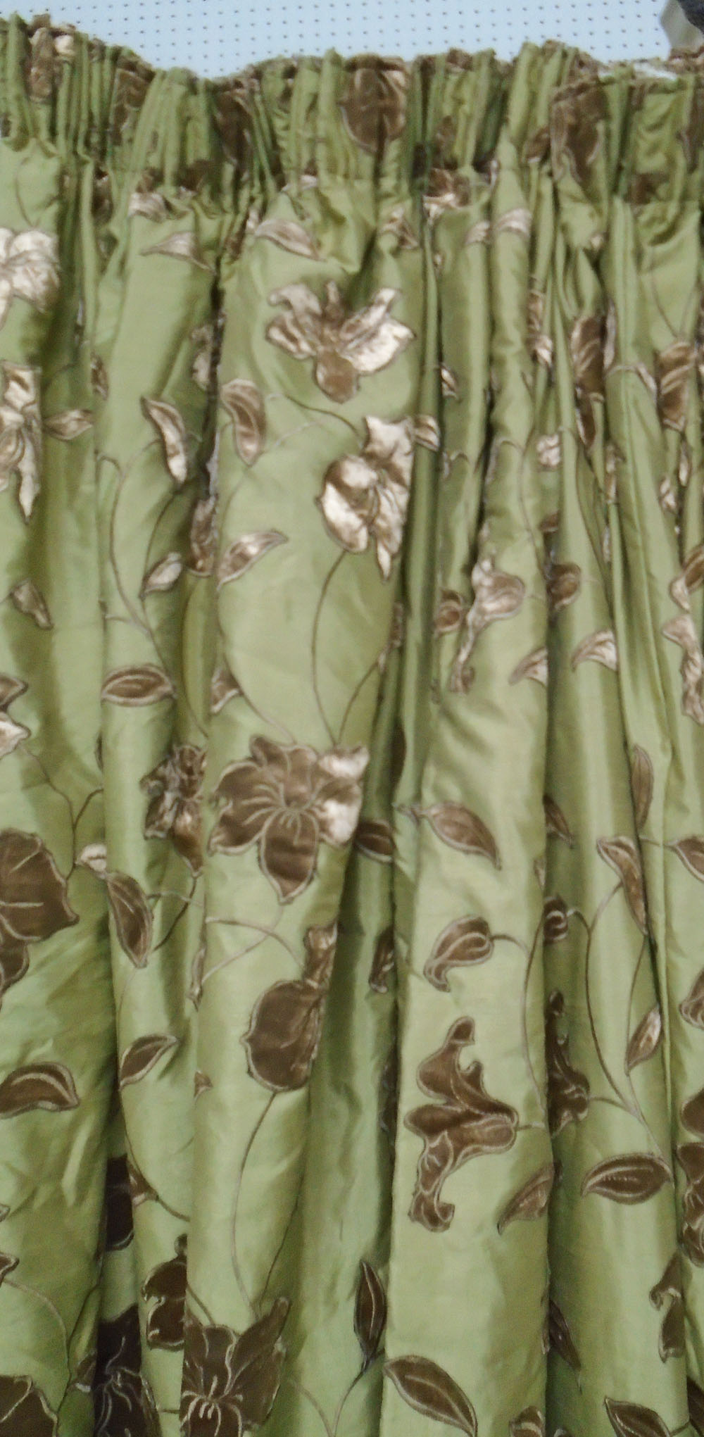 CURTAINS, a pair, floral design on a gold field, 83cm gathered by 215cm drop.