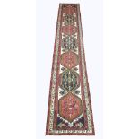 HERIZ RUNNER, 400cm x 73cm, pole medallions on an ivory field within multiple geometric borders.