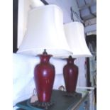 LAMPS, a pair, burgundy urn shaped bases with gilt detail, with shades, each 78cm H overall.