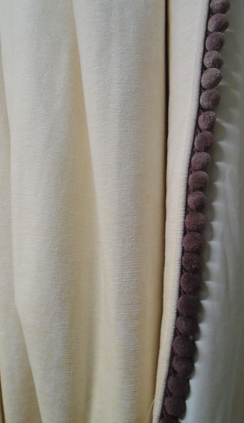 CURTAINS, two pairs, cream chenille lined with bobble edge, 95cm gathered by 240cm drop.