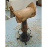 BAR STOOL, in the form of a saddle rotating on metal base, 95cm H.