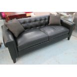 SOFA, two seater, in black pocketed leather on square ebonised supports plus two scatter cushions,