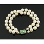 PEARL DOUBLE STRAND BRACELET set with an art deco diamond and jade clasp,