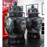 LIDDED JARS, a pair, in black Fornasetti style, 48cm H.