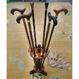 STICK STAND, in black lacquer with six walking sticks, 96cm H.