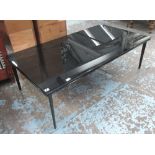 'JAAN' LOW TABLE, the black glass top on metal base, by Walter Knoll, 71cm D x 130cm L x 42cm H.