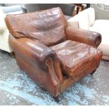 ARMCHAIR, worn brown leather and close nailed with back and seat cushions, 103cm W.