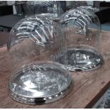 CHEESE DOMES, a pair, in engraved glass on chromed metal base, 30cm H.