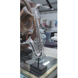 STUDY OF A SAXOPHONE, on a display stand, 66cm H overall.