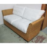 BELTON SOFA, three seater, in a plaited and woven water hyacinth finish with lacquered black feet,