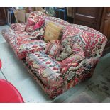 SOFA, three seater, upholstered in kilim fabric on turned feet with castors,