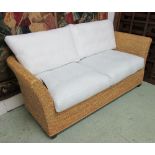 BELTON SOFA, two seater, in a plaited and woven water hyacinth finish with lacquered black feet,