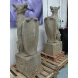 HOUNDS, a pair, sitting on stone pedestals with shields, 137cm H.