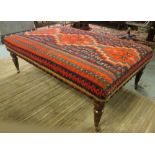 HEARTH STOOL, 19th century style rectangular kilim covered with turned supports and castors,