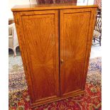 SIDE CABINET, Edwardian satinwood with a pair of panelled cupboard doors enclosing shelves,