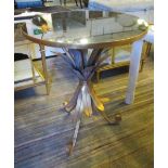 OCCASIONAL TABLE, with a circular mirrored top on swept scrolled supports with leaf decoration,