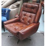 EASY ARMCHAIR, Norwegian design tan buttoned leather revolving a five point chromed base.