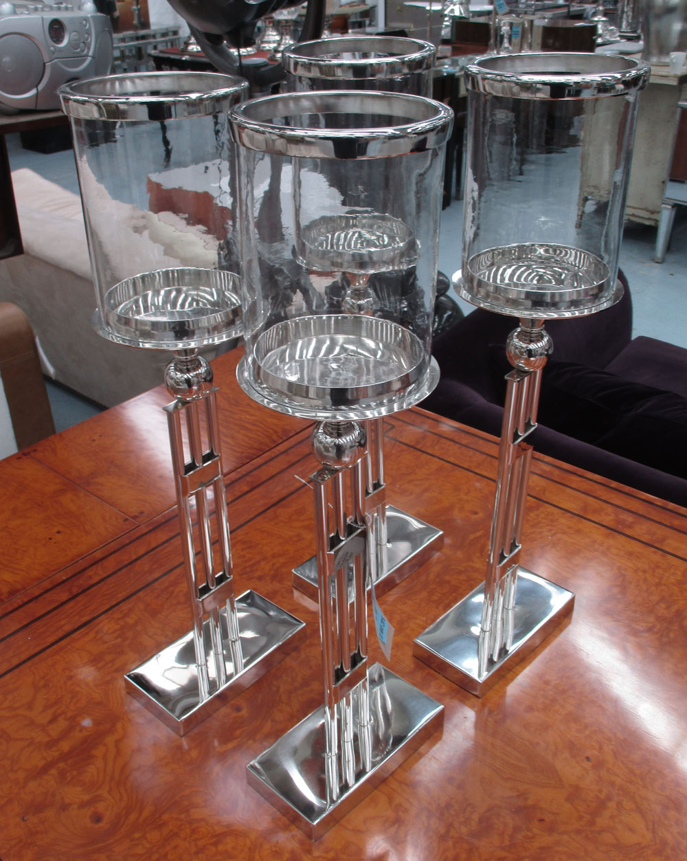 TABLE CANDLE LIGHTS, a set of four, B&B Italia style plated metal bases with circular glass tops,