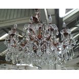 CHANDELIER, twelve branch within a bronzed frame with glass drops, 86cm W x 48cm H plus chain.